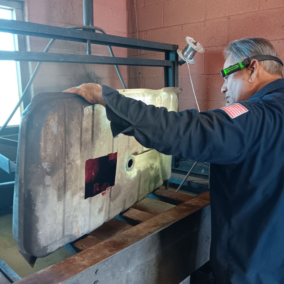 Johnny sealing a repaired automotive fuel tank in the Victorville shop